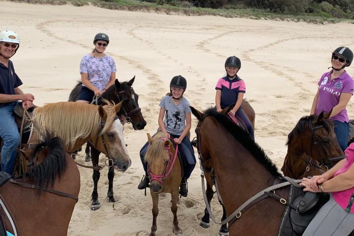 a group of people riding on the back of a horse