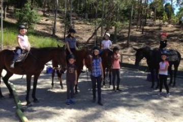 a group of people riding on the back of a horse