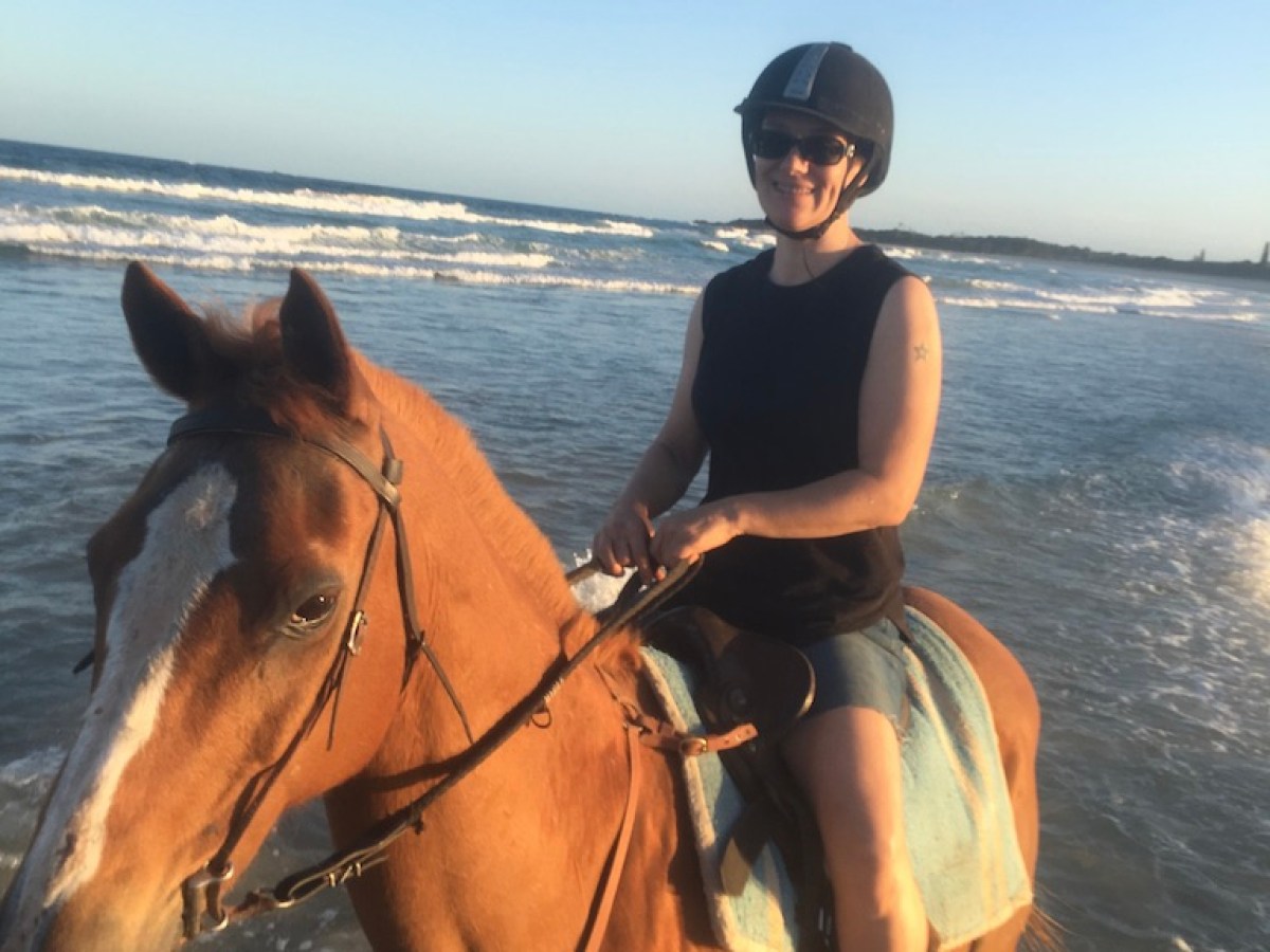 a person riding a horse in a body of water