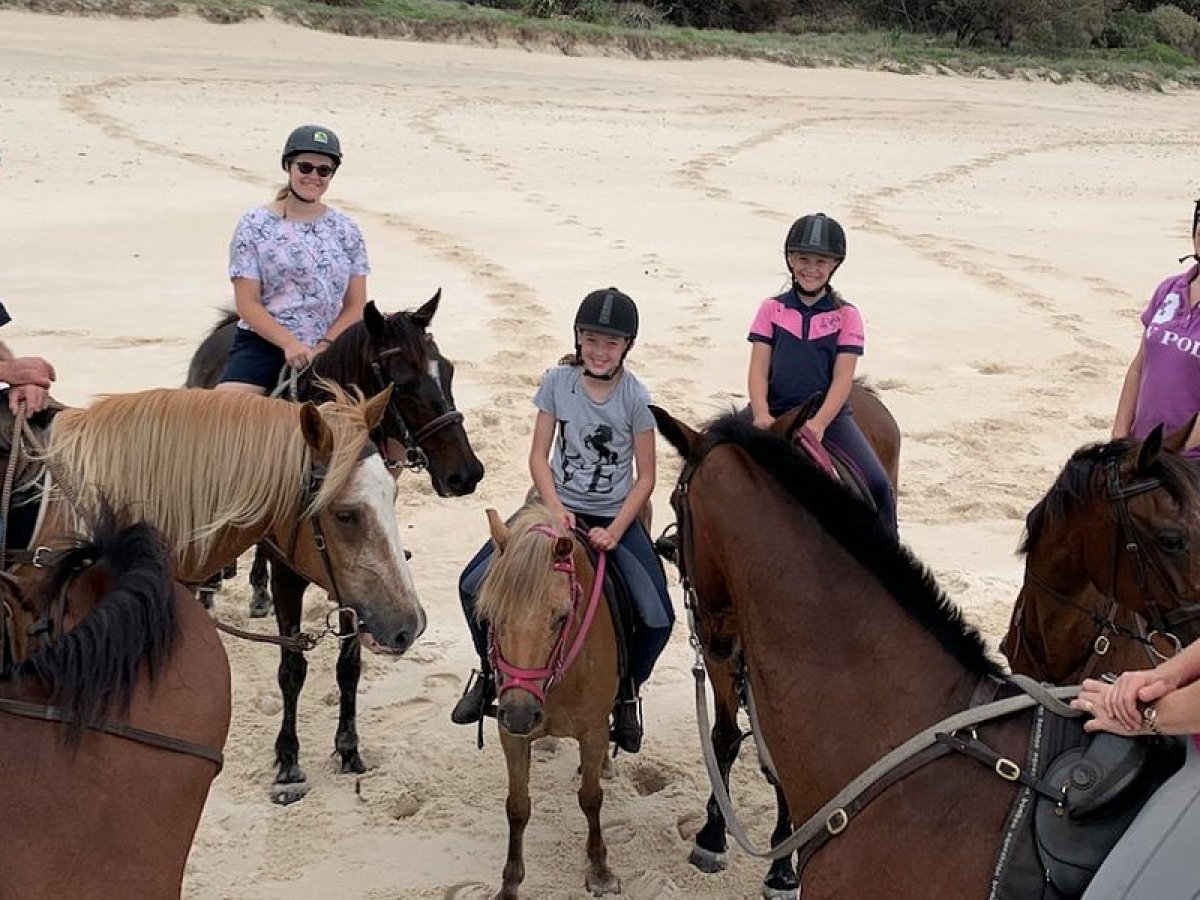 a group of people sitting on a horse