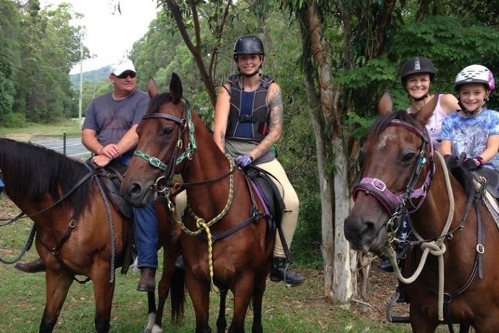 a group of people standing next to a horse