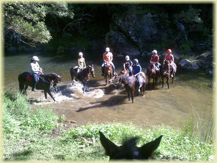 a group of people riding on top of a dirt field