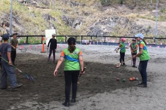 a group of people that are standing in the sand