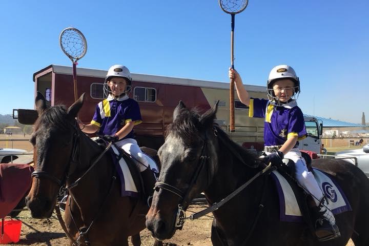 a group of people standing next to a horse