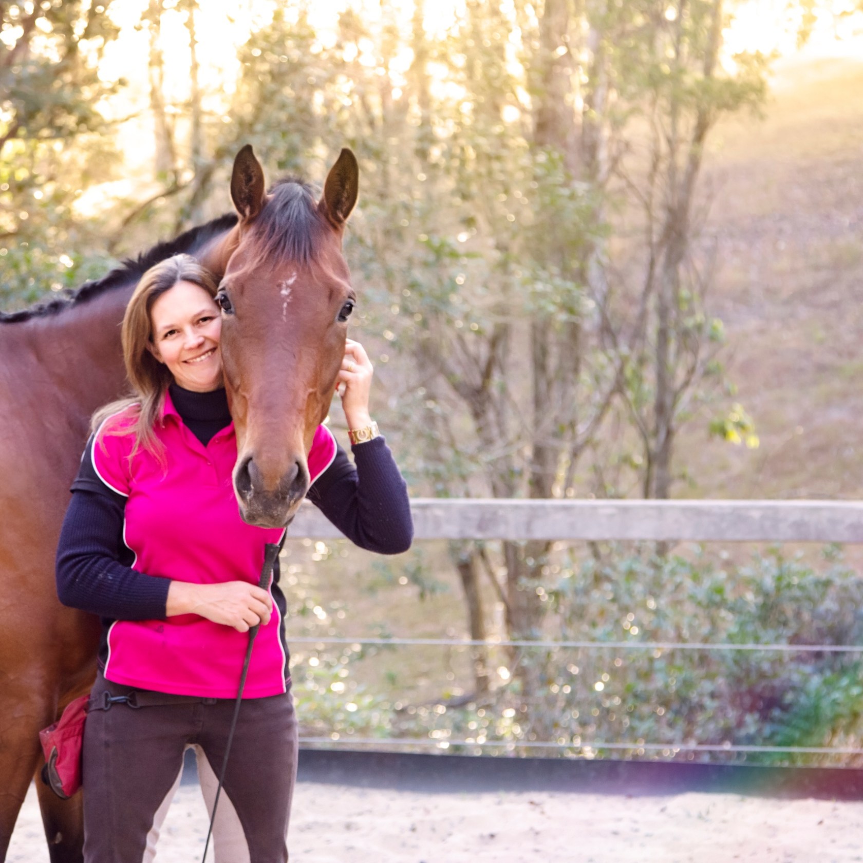 a woman standing next to a horse